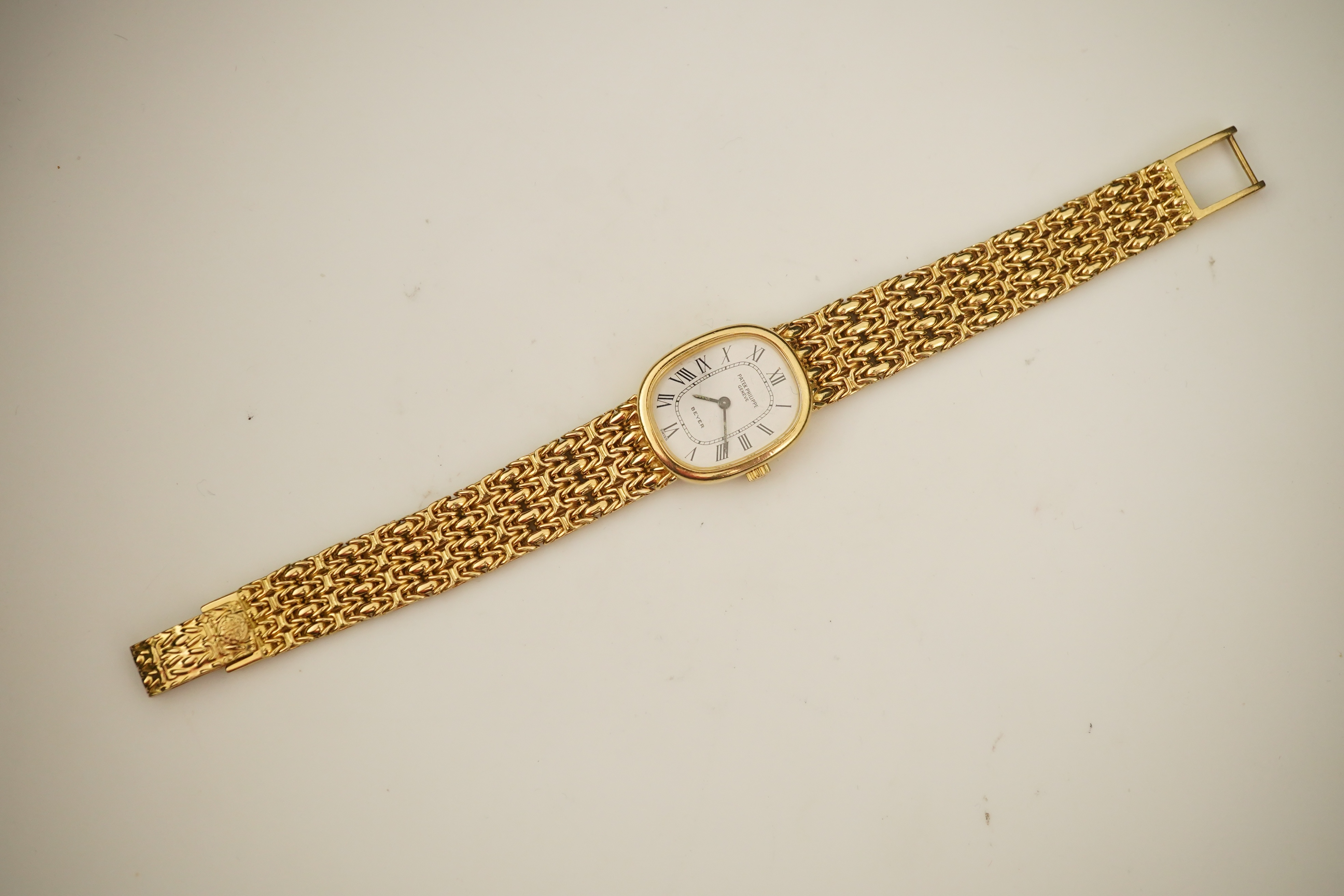 A lady's 18ct gold Patek Philippe manual wind wrist watch, on an integral 18ct gold Patek Philippe bracelet